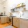 brightly lit, open kitchen next to living room