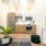 furnished, well lit living room open to the kitchen