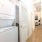 stackable washer and dryer in lighted laundry closet